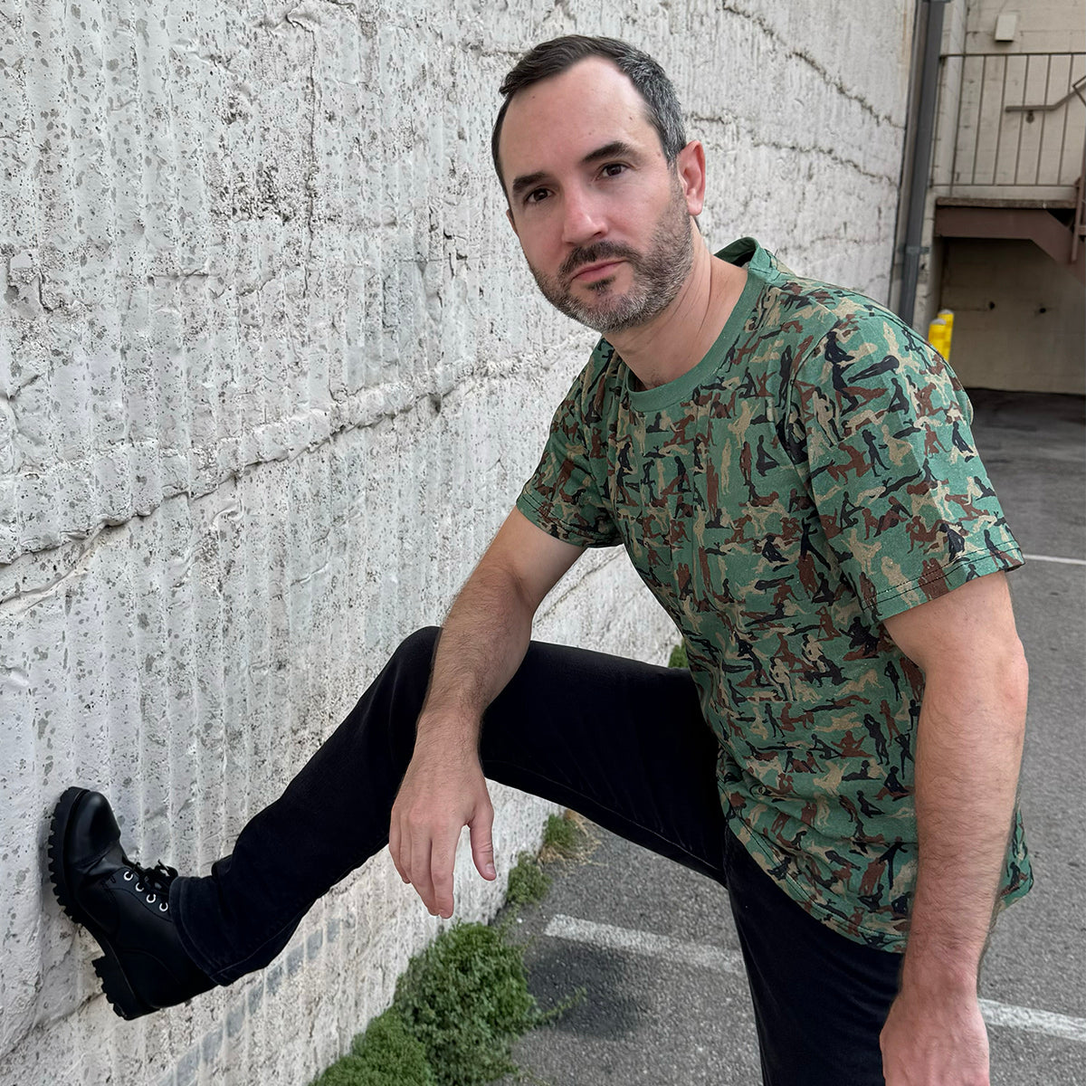 person standing wearing a Kama Sutra Camo Sexy NSFW T-shirt