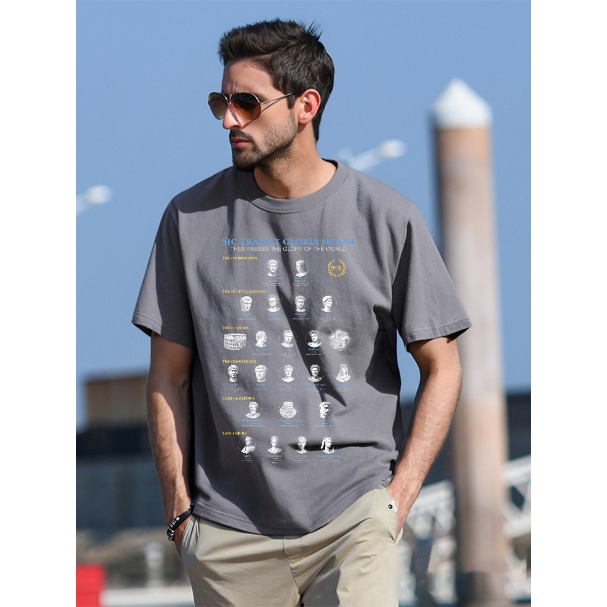 Gray Roman Empire history t-shirt worn by model, showing complete visual guide to Western Roman emperors with SPQR laurel wreath, Colosseum, and Pompeii illustrations