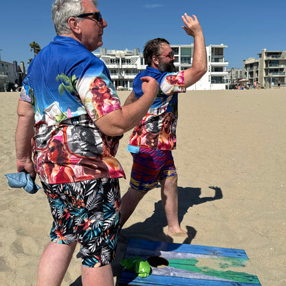 Two guys wearing They Live Miami-flavored Hawaiian style button down shirt at beach