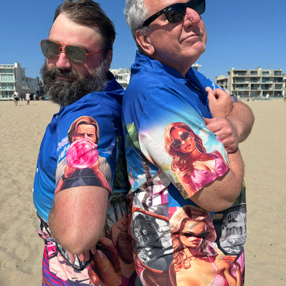 Two guys wearing They Live Miami-flavored Hawaiian style button down shirt back to back at beach