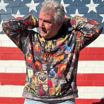 Man in Covert Agency hoodie posing in front of a large American flag mural.