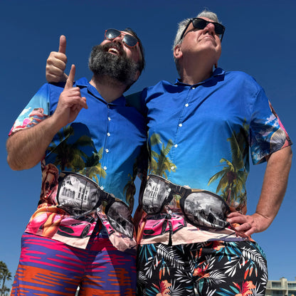 Two dudes wearing "They Live" movie inspired Hawaiian style button down shirt at beach