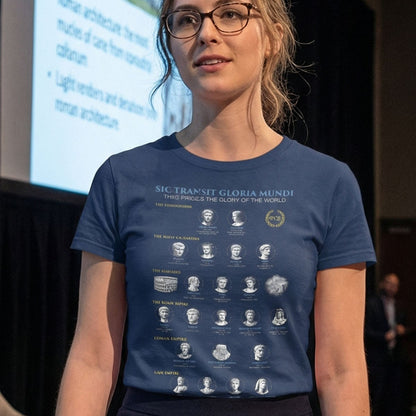 Woman wearing a blue t-shirt with text and graphics, standing in front of a screen in an indoor setting.